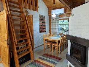 a dining room with a table and a fireplace at Nelisyöte A in Syöte