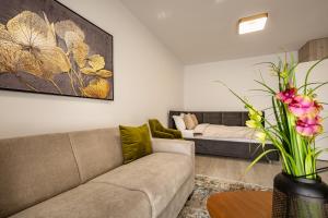 a living room with a couch and a table at Urban Plaza Alpine Escape Studio with Free Parking, Balcony, Washer & Dryer in Braşov