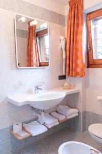 a bathroom with a sink and a mirror at Hotel Garni Rin Da Rin in Livigno