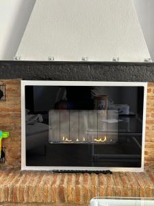 a fireplace in a living room with a fire place at Casa Jardin- Lovely 2bed 2bath flat Calahonda - 475m to the beach in Sitio de Calahonda
