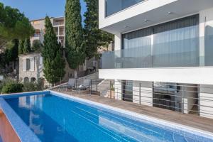 a swimming pool in front of a building at Villa Brzet - Luxury Boutique Apartments in Omiš