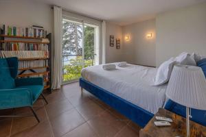 a bedroom with a bed and a book shelf at Villa 83 Veyrier - Veyrier du lac in Veyrier-du-Lac