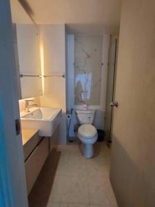 a bathroom with a white toilet and a sink at Seaview Atlantis Condo Resort Jomtien Beach Water Park in Jomtien Beach