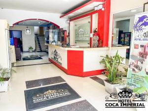 a restaurant with a red and white counter at Hotel Coca Imperial in Puerto Francisco de Orellana