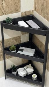 a black shelf with papers and plants on it at ماكس الفندقية 15 in Riyadh