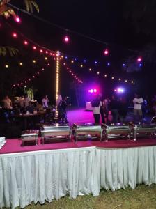 a stage with a group of people dancing on a pink carpet at "D'BAMBOO KAMP" Desa Wisata Ekang in Lagoi