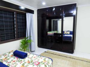 a living room with a couch and a mirror at Yaubula Accommodation 2 in Nadi