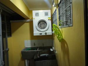 a bathroom with a washing machine and a sink at Yaubula Accommodation 2 in Nadi
