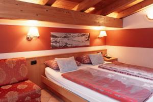Postel nebo postele na pokoji v ubytování Hotel Garni Rin Da Rin