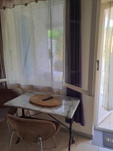 a table with a plate on it next to a window at Appartements Luccisano in Borgo