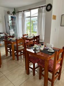 uma sala de jantar com mesas e cadeiras de madeira em MS Hotel Campos 26 em Ushuaia