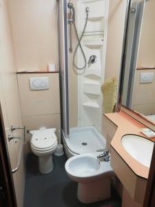 a bathroom with a toilet and a shower and a sink at HOTEL GIORDANA in Loano