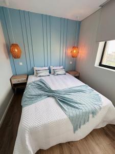 a bedroom with a large bed with blue walls at Casa Sol in Lavra