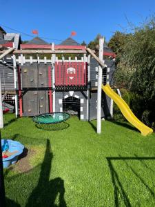 a playground with a slide and a play structure at Willa Jolka - parking bezplatny, plac zabaw, wiata grillowa in Krynica Zdrój