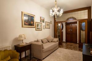 uma sala de estar com um sofá e um lustre em Central Apartment Ca' dei Ferro - MURANO Venice em Murano
