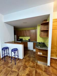 a kitchen with two purple bar stools in it at Torremolinos Plaza Del Ayuntamiento Sun&Beach in Torremolinos