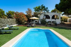 a swimming pool in the yard of a house at Ca Nostra Ibiza in Port des Torrent