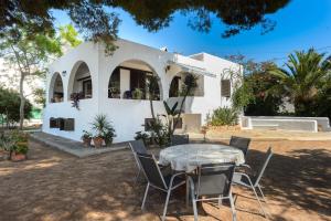 a table and chairs in front of a house at Ca Nostra Ibiza in Port des Torrent