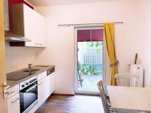 a kitchen with a sink and a door to a yard at Nice Apartment in Brühl in Brühl