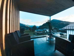 a room with a balcony with a view of the mountains at Barbilihof in Raggal