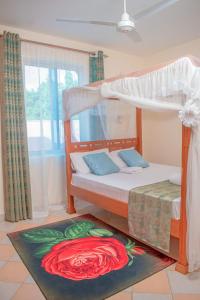 a bedroom with a bunk bed with a flower rug at Unique Homes One- Bedroom Apartment in Kilifi