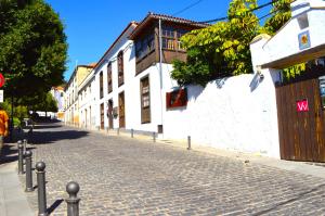 a cobblestone street next to a white building at Ziggys Mountain Retreat in Vilaflor