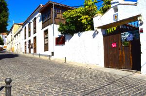 a cobblestone street with a building with a wooden door at Ziggys Mountain Retreat in Vilaflor
