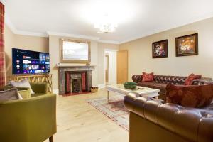 a living room with leather furniture and a fireplace at NEW! Luxurious Cottage in Durham by Stay With Us, Ideal for Large Groups & Families, Hot Tub, Sleeps 10! in Bishop Auckland