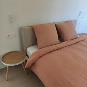 a bedroom with a bed with a table next to it at De Molenlos in Zottegem