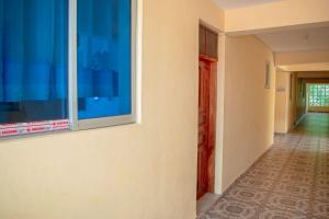 a hallway of a house with a window at Unique Homes One- Bedroom Apartment in Kilifi