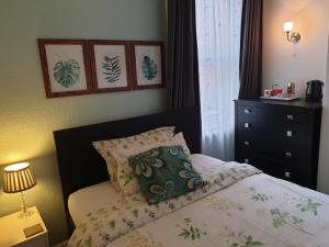 a bedroom with a bed with a pillow and a dresser at St Michael's Boutique Guest House, North Bay, Scarborough with free parking and fast wi-fi in Scarborough +114 photos
