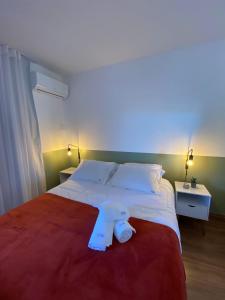 a bedroom with a large bed with a pair of shoes on it at Flat Lake Side Decoração Retrô in Brasilia +36 photos