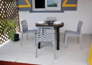a table and chairs sitting on a patio at Le Gîte Des Plantations in Capesterre-Belle-Eau