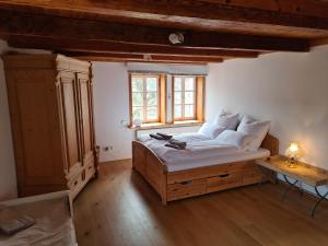 a bedroom with a large bed with a window at Ferien Fachwerkhaus in Olsberg