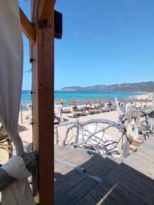 a view of a beach with chairs and the ocean at Il Miraggio Tanca Piras in Nebida