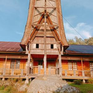 a wooden building with a tower on top of it at Angel's Homestay Batutumonga in Rantepao