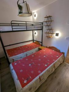 a bedroom with two bunk beds in a room at HIVER COMME ETE in Forest des Baniols