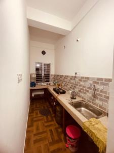 a kitchen with a sink and a counter top at Comfort Family Homestay in Guwahati