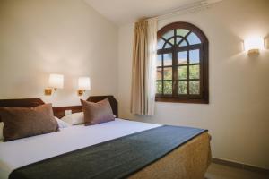 A bed or beds in a room at Maspalomas Resort by Dunas