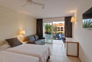 a hotel room with two beds and a balcony at Mirador Maspalomas by Dunas in Maspalomas