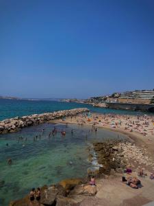 a group of people in the water at a beach at Maï Homes - La Villa Bompard in Marseille