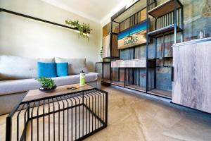 a living room with a couch and a table at Suites & Villas by Dunas in Maspalomas