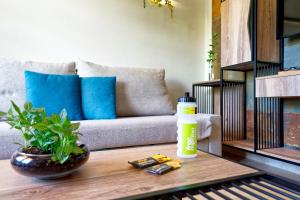 a living room with a couch and a bottle on a table at Suites & Villas by Dunas in Maspalomas