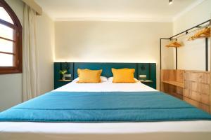 a bedroom with a large bed with orange pillows at Suites & Villas by Dunas in Maspalomas