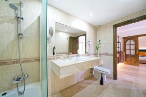 a bathroom with a sink and a shower at Suites & Villas by Dunas in Maspalomas