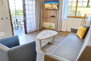 a living room with a couch and a table at Suites & Villas by Dunas in Maspalomas
