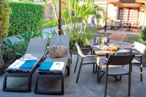 a table and chairs sitting on a patio at Suites & Villas by Dunas in Maspalomas
