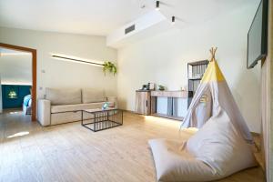 a living room with a couch and a hammock at Suites & Villas by Dunas in Maspalomas