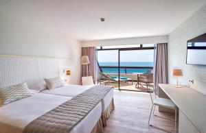 a hotel room with a bed and a view of the ocean at Don Gregory by Dunas - Adults Only in San Agustin
