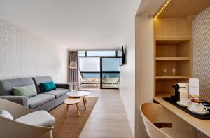 a living room with a couch and a table at Don Gregory by Dunas - Adults Only in San Agustin